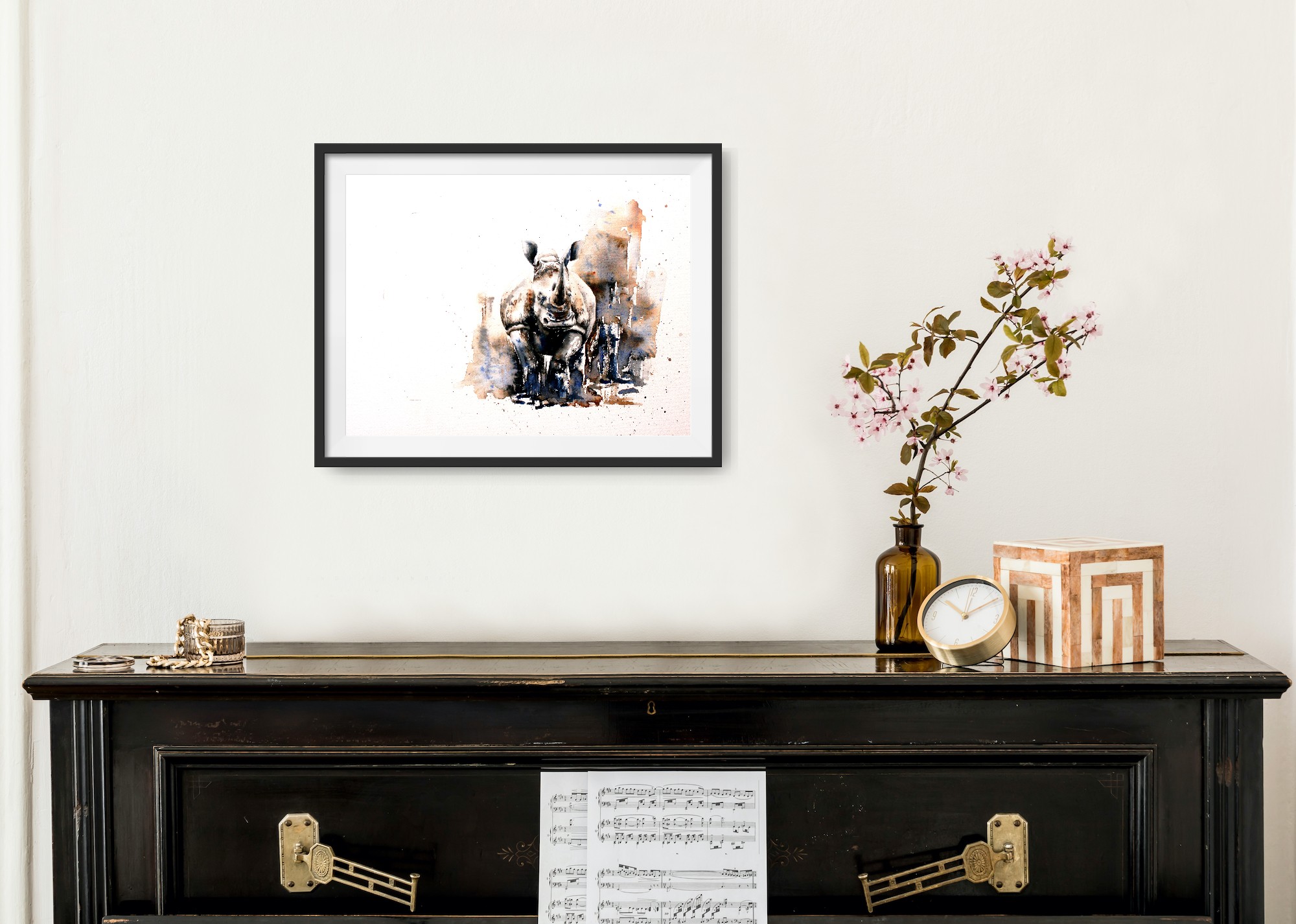 Small rhino print above a black piano